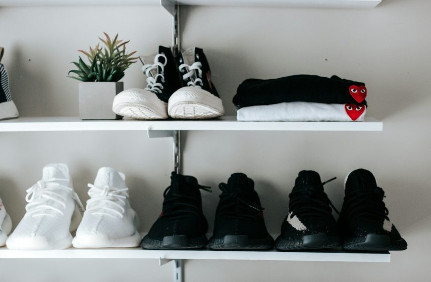 three pairs of black and white shoes on floating shelf