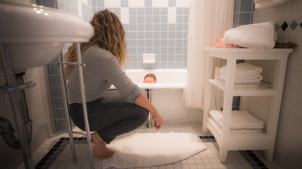 woman in gray long sleeve shirt sitting on white chair