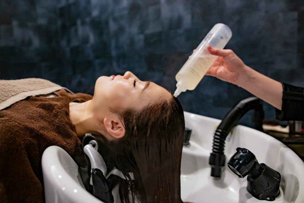 a woman getting her hair washed with a hair dryer