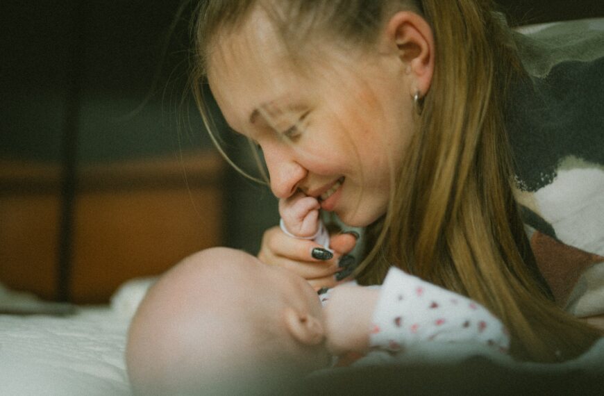 a woman holding a baby in her lap