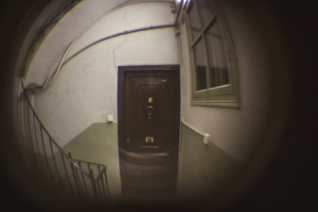 a door is seen through a circular lens