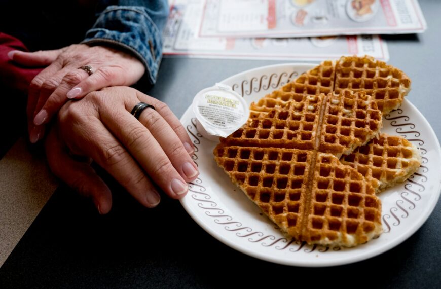 a person holding a sandwich