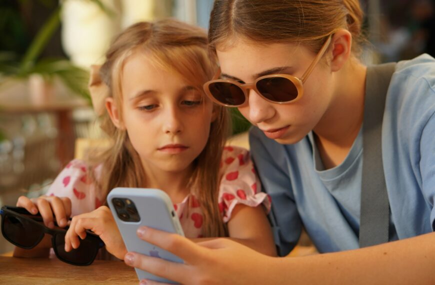 A woman and a girl looking at a cell phone