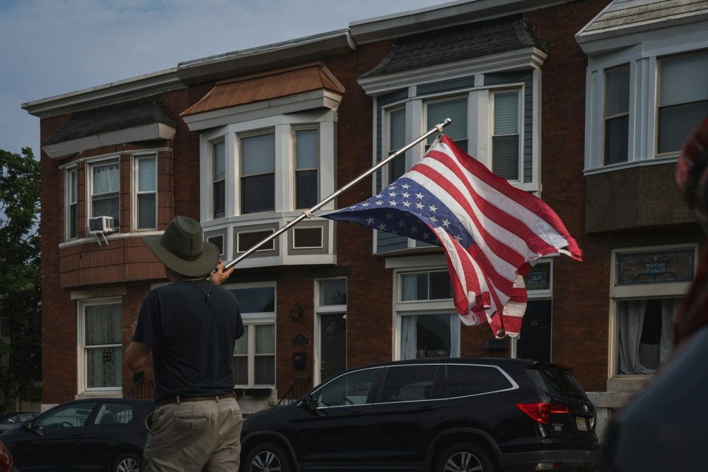 A person waves an american flag.