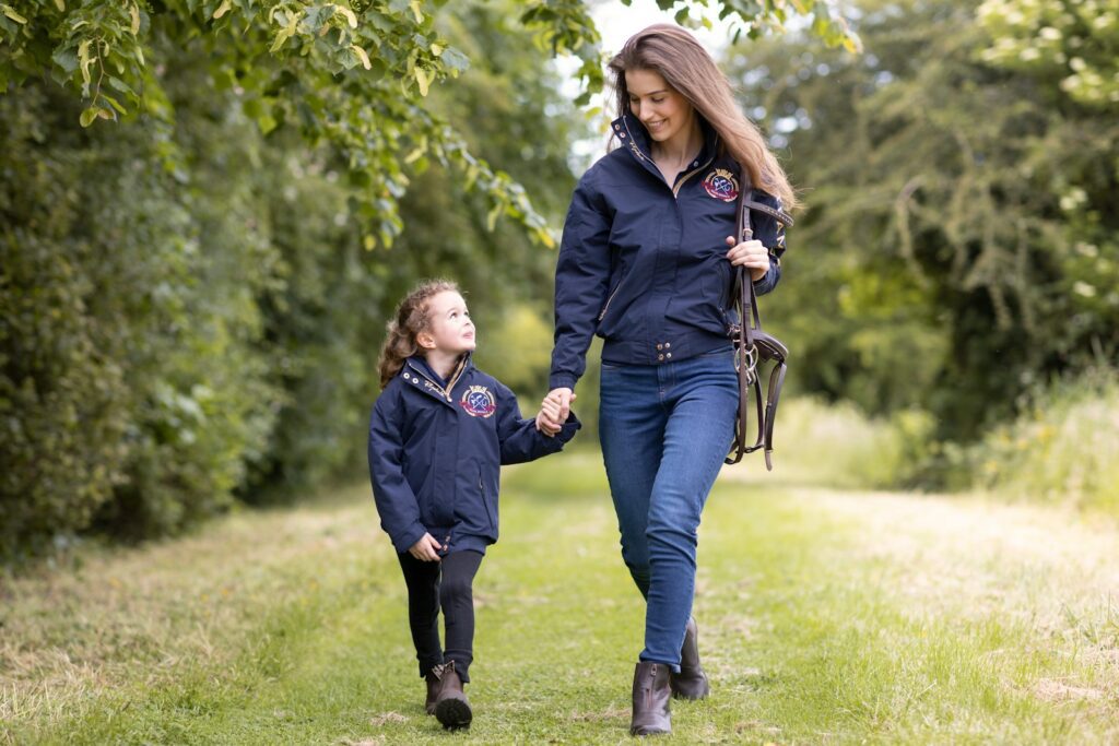 a woman and a child walking down a path