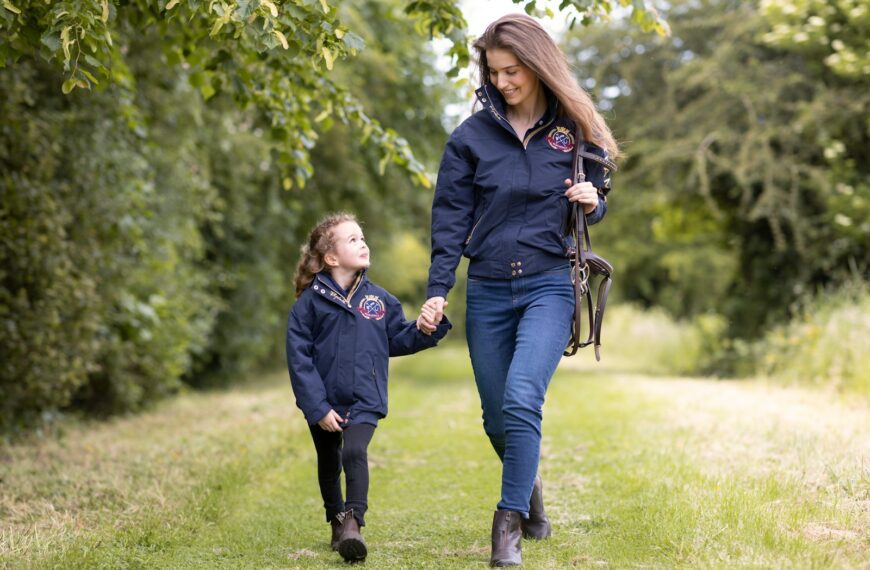 a woman and a child walking down a path