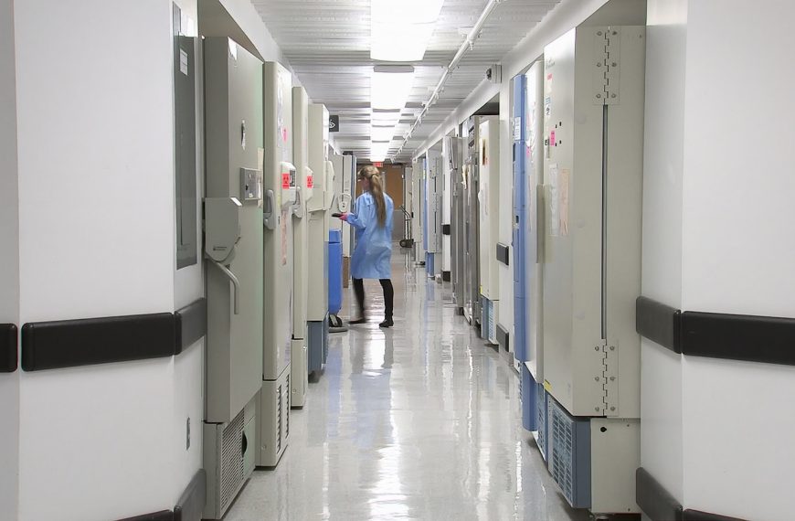 man in blue dress shirt walking on hallway