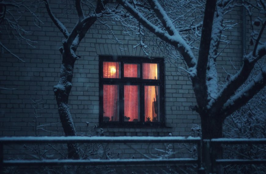 A building with a window and a snowy night