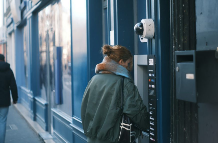 Woman using an atm on a city street