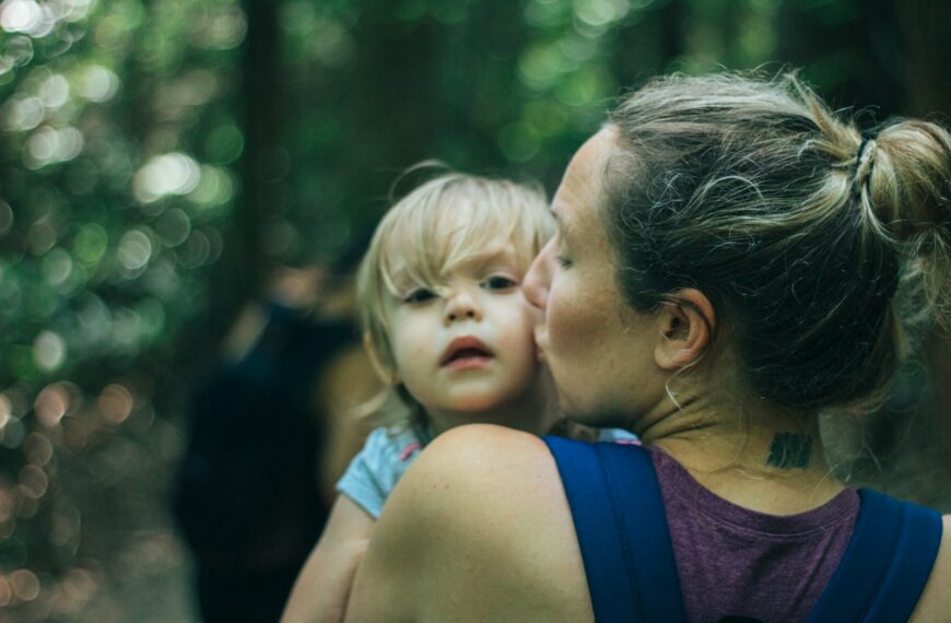 a woman holding a little girl in her arms