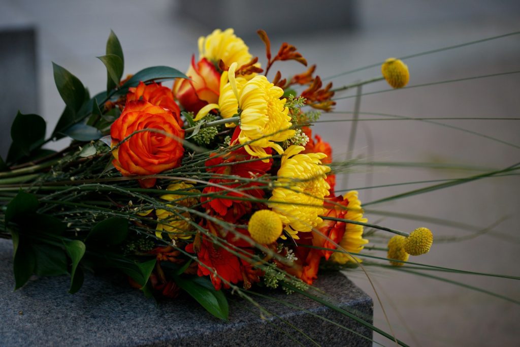 a bouquet of flowers sitting on top of a stone block