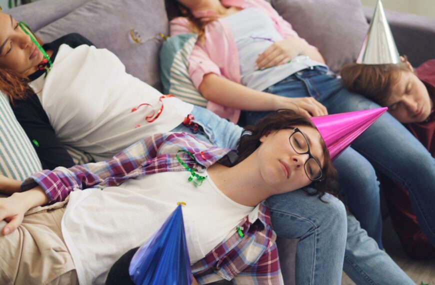 a group of people laying on top of a couch