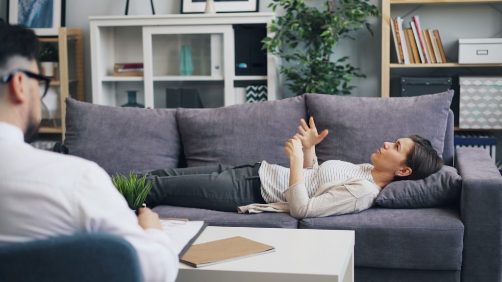 a woman laying on a couch in a living room