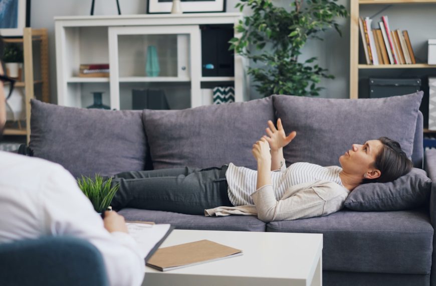 a woman laying on a couch in a living room
