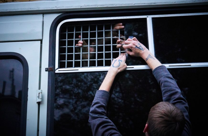 person in black long sleeve shirt holding smartphone