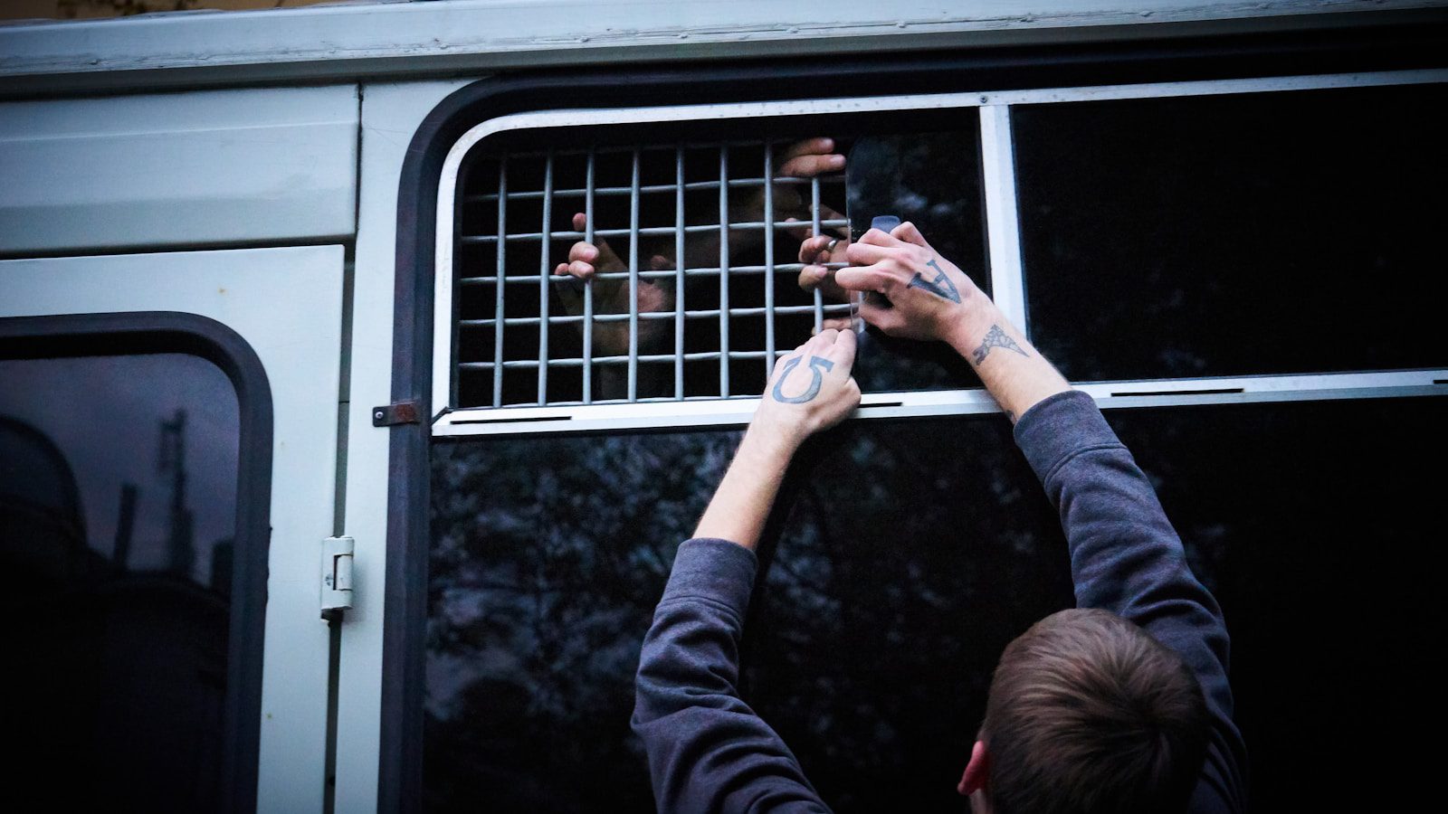 person in black long sleeve shirt holding smartphone