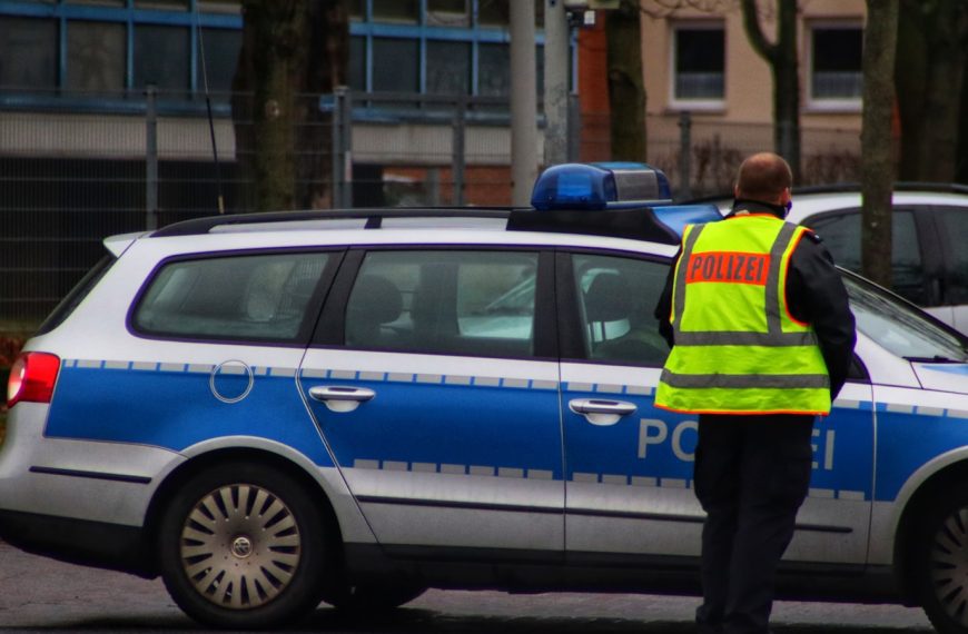 a police officer standing in front of a police car