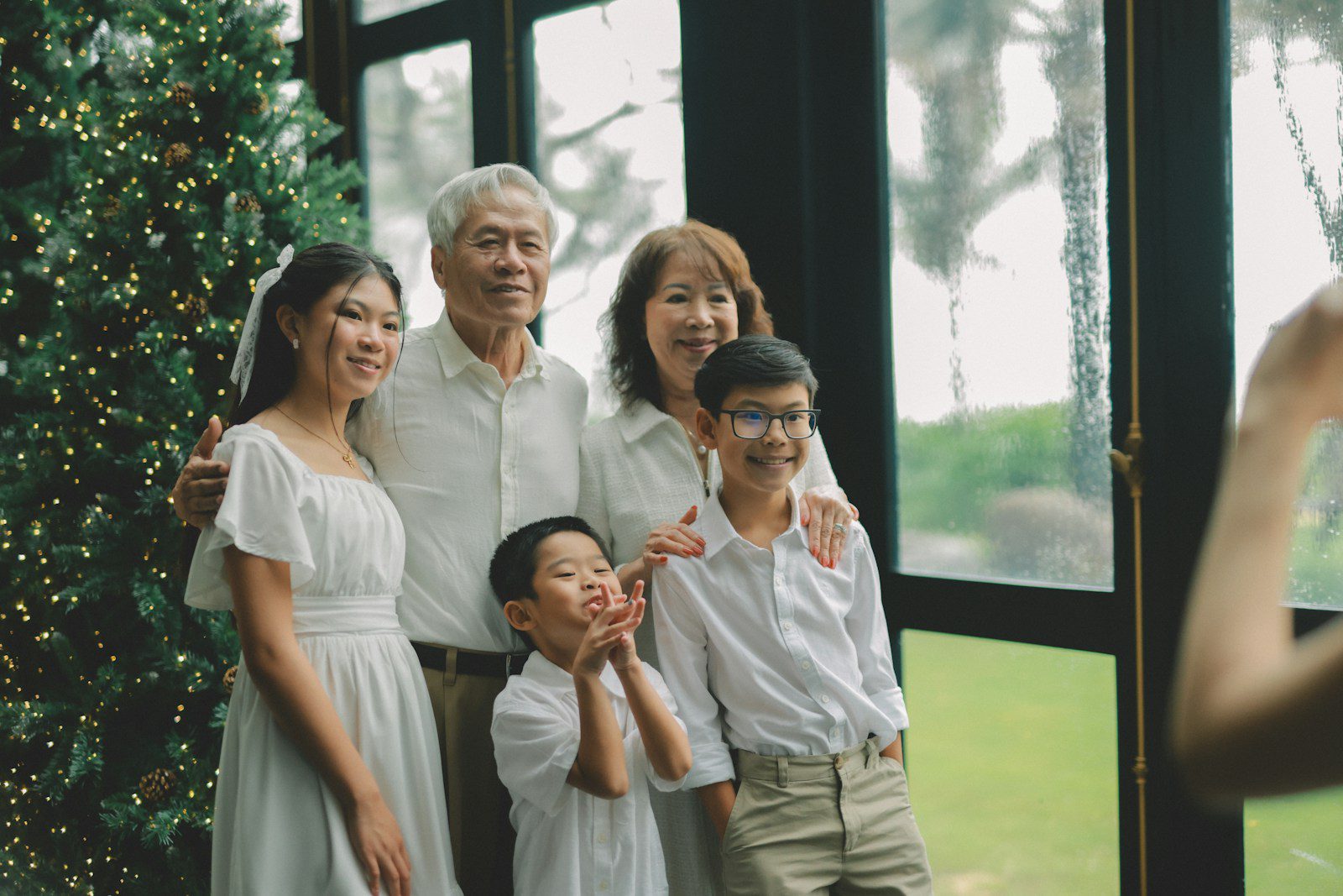 A multi-generational family posing for a christmas photo.