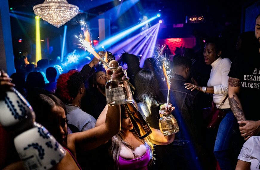 woman in purple tank top singing on stage