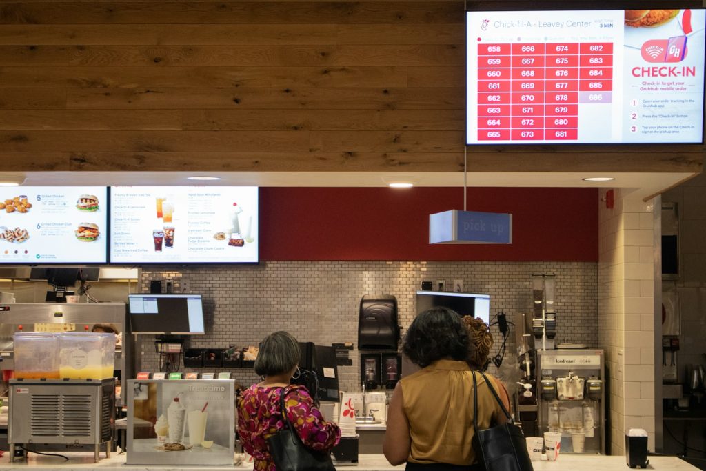 a couple of women standing in front of a counter