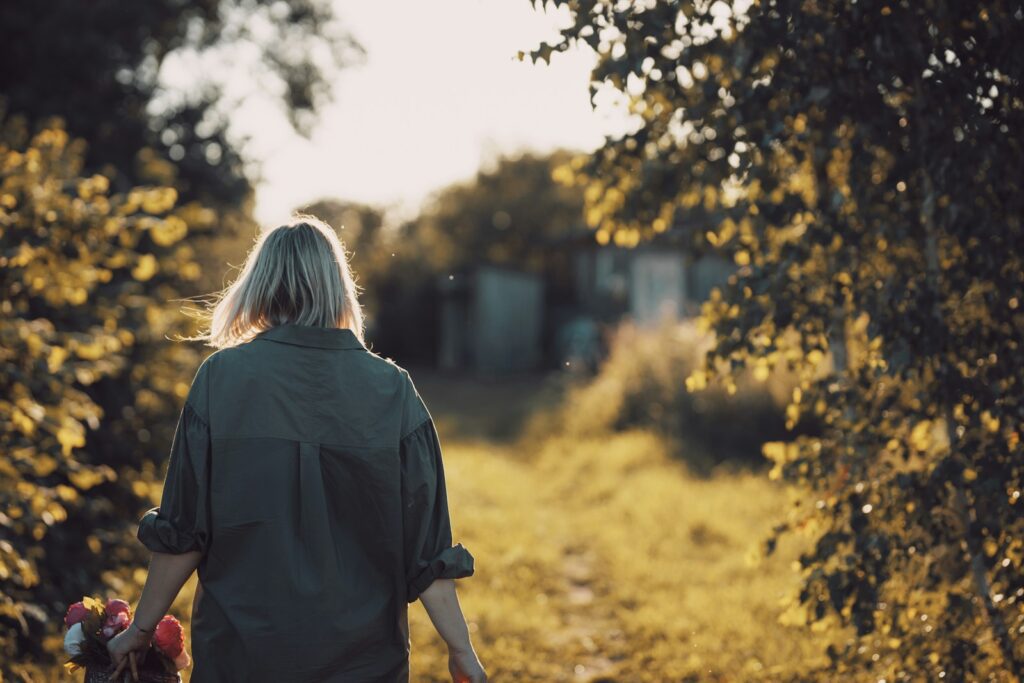 woman in black shirt standing near trees during daytime