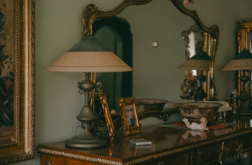 a dresser with a lamp on top of it