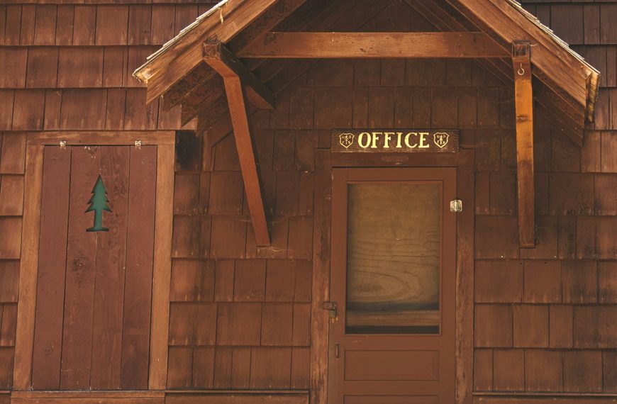 a wooden building with a sign on the front of it
