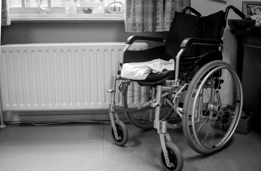 a wheelchair sitting in a room next to a radiator