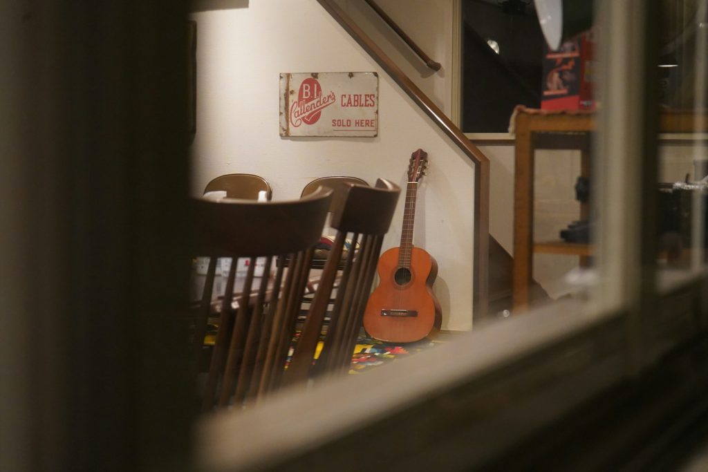 a guitar leaning against a wall