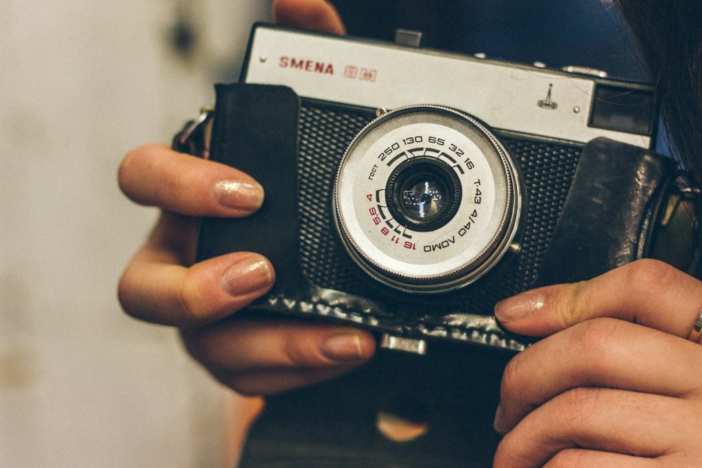 a woman holding a camera in her hands