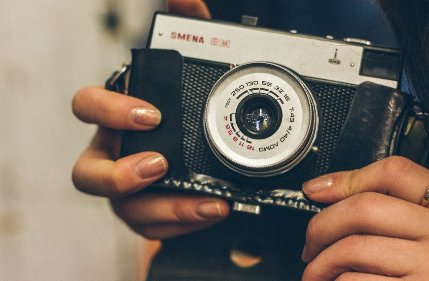 a woman holding a camera in her hands