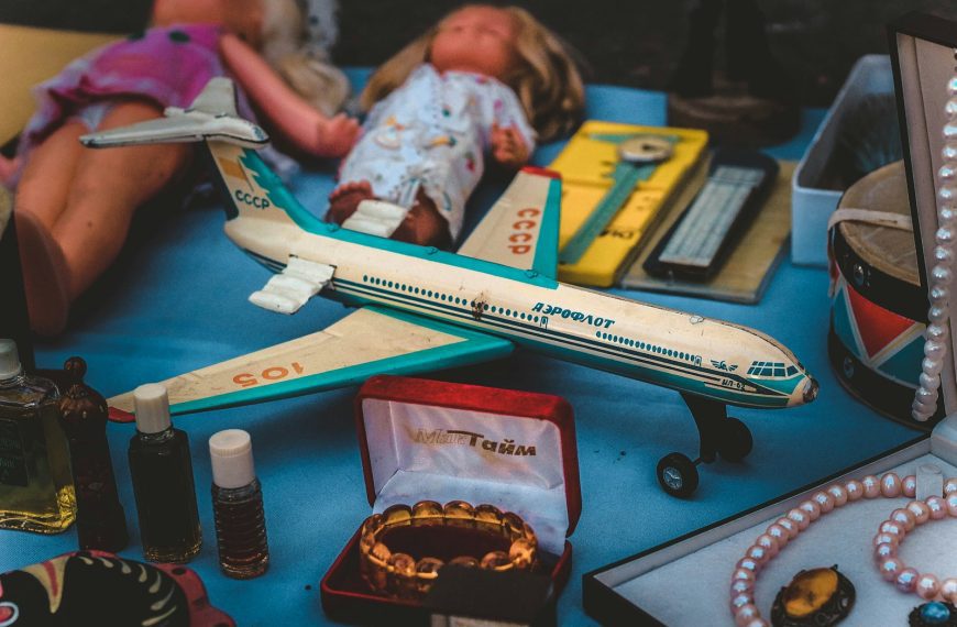 closeup photo of airplane scale model and jewelry