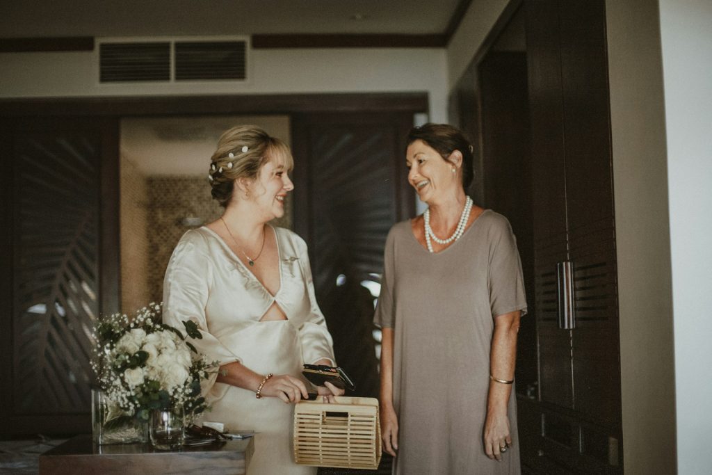 two women standing next to each other in a room