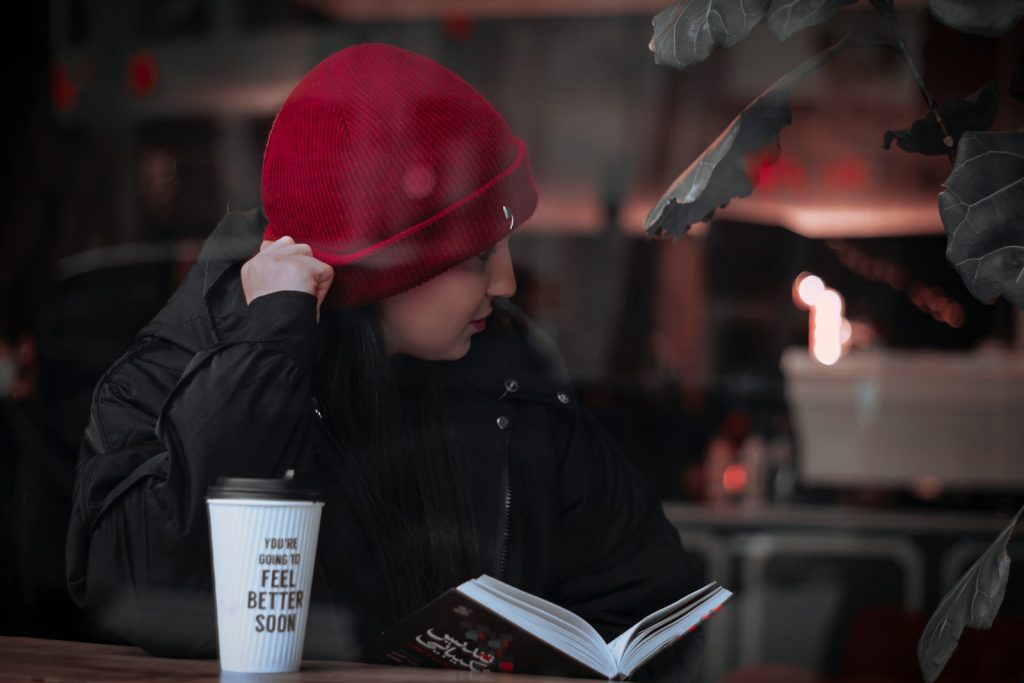 a person sitting at a table with a cup of coffee