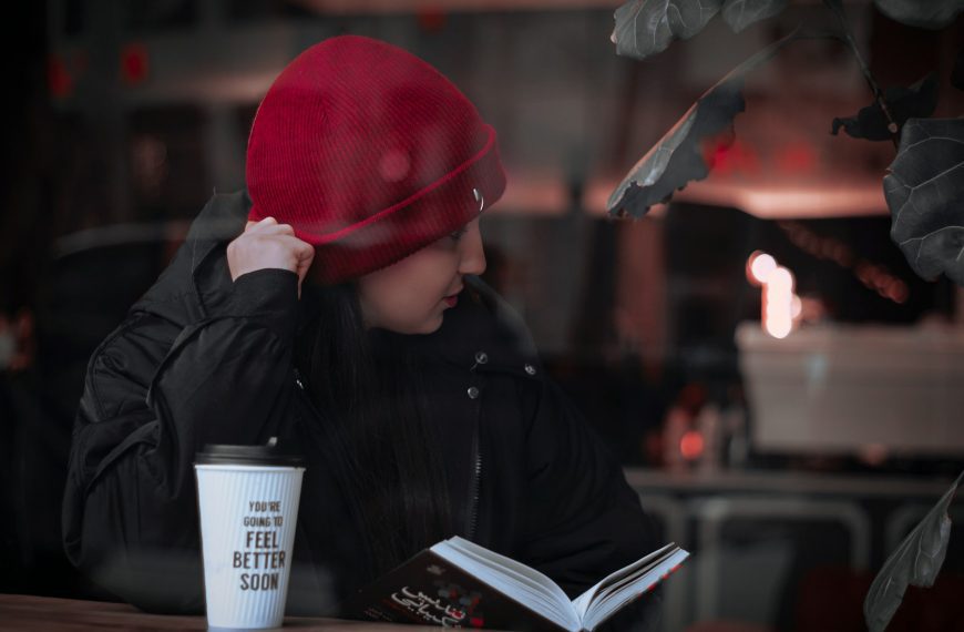 a person sitting at a table with a cup of coffee