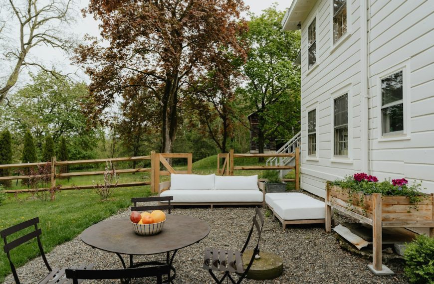 a patio with a table and chairs and a couch