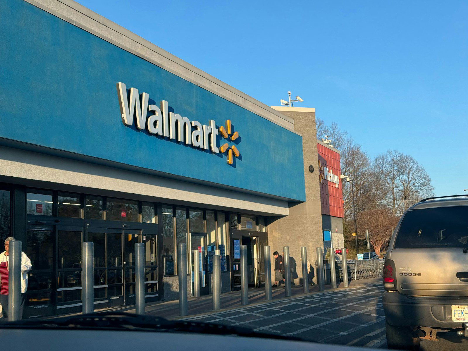 a walmart store with a car parked in front of it