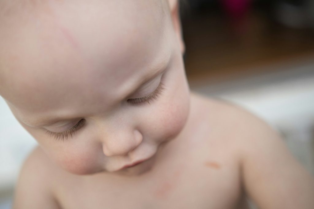 a close up of a small child with no shirt on