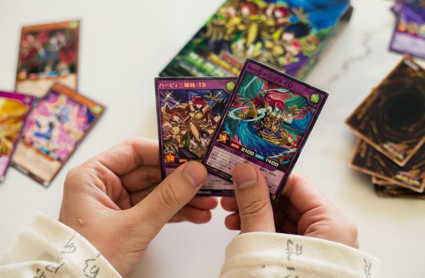 Hands are holding up two yu-gi-oh! cards.