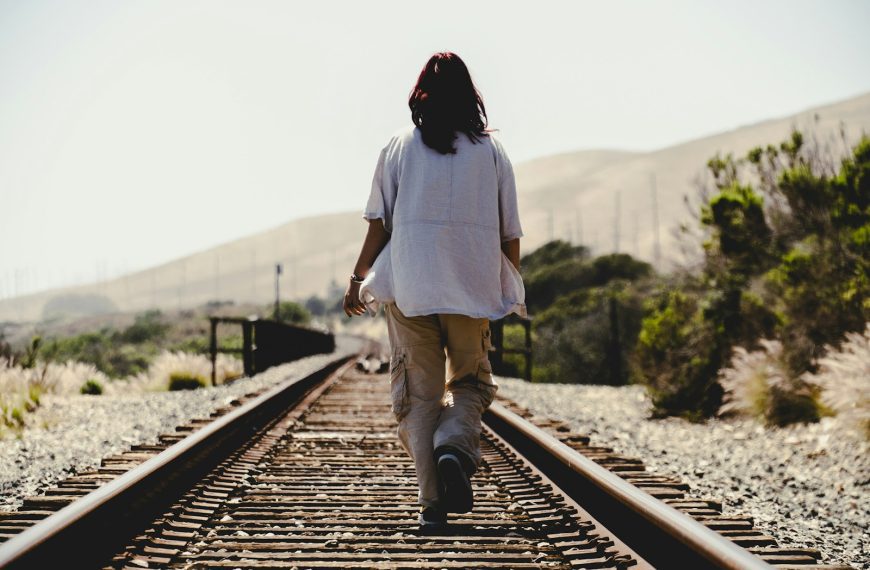 a person walking down a train track