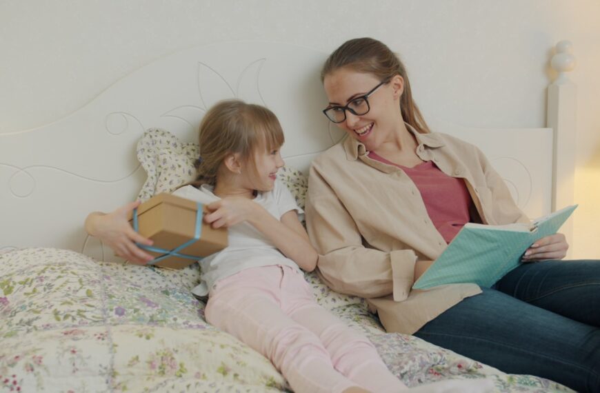 Daughter gives mother a gift while reading