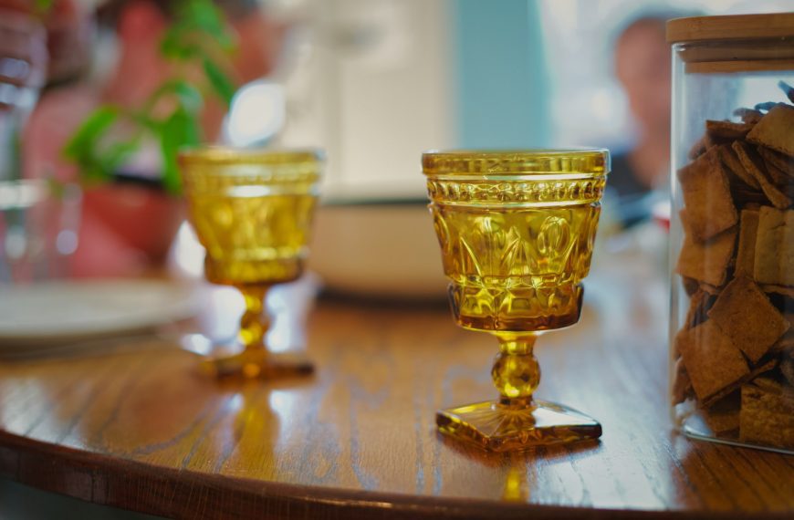 Two amber goblets on a wooden table