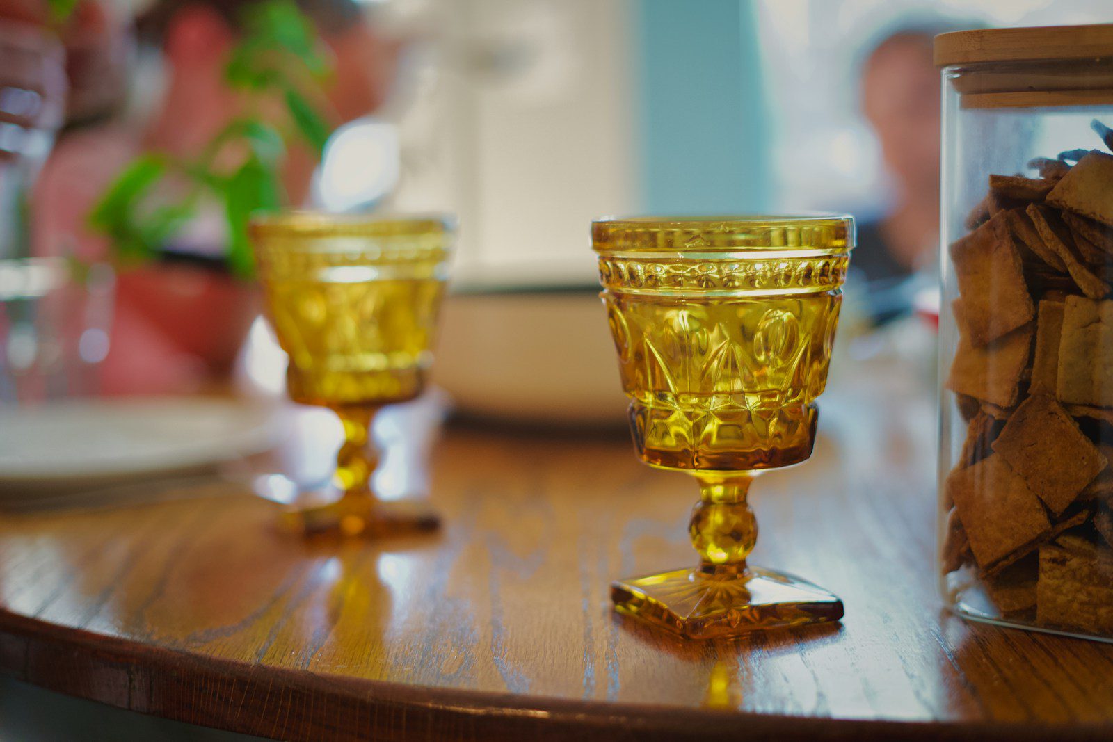 Two amber goblets on a wooden table