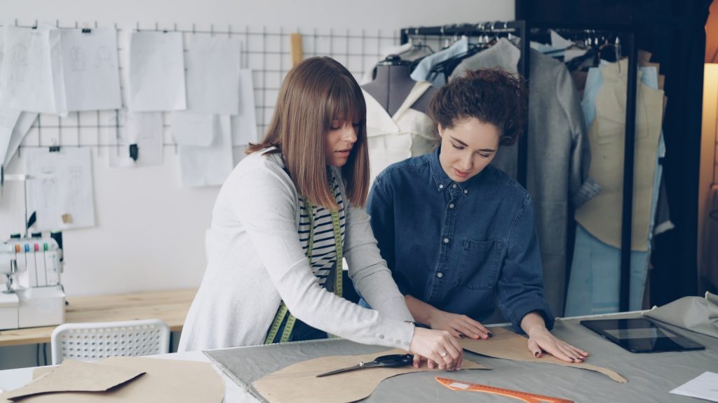 Fashion designers work together on a project.