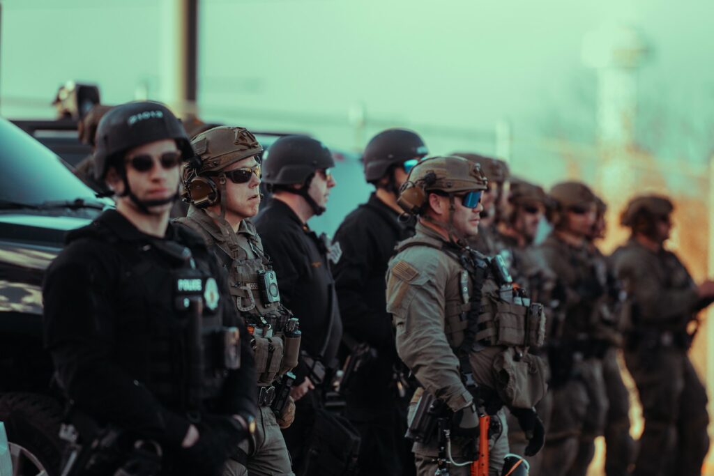 Heavily armed police officers standing in a line.