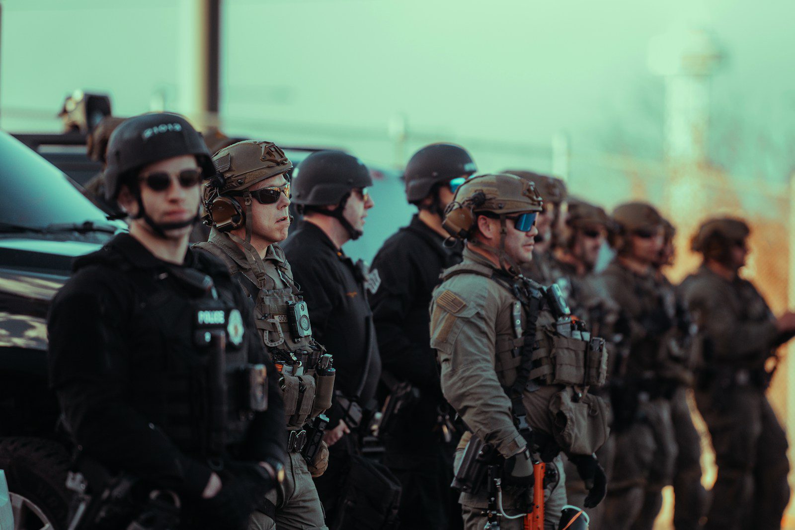 Heavily armed police officers standing in a line.
