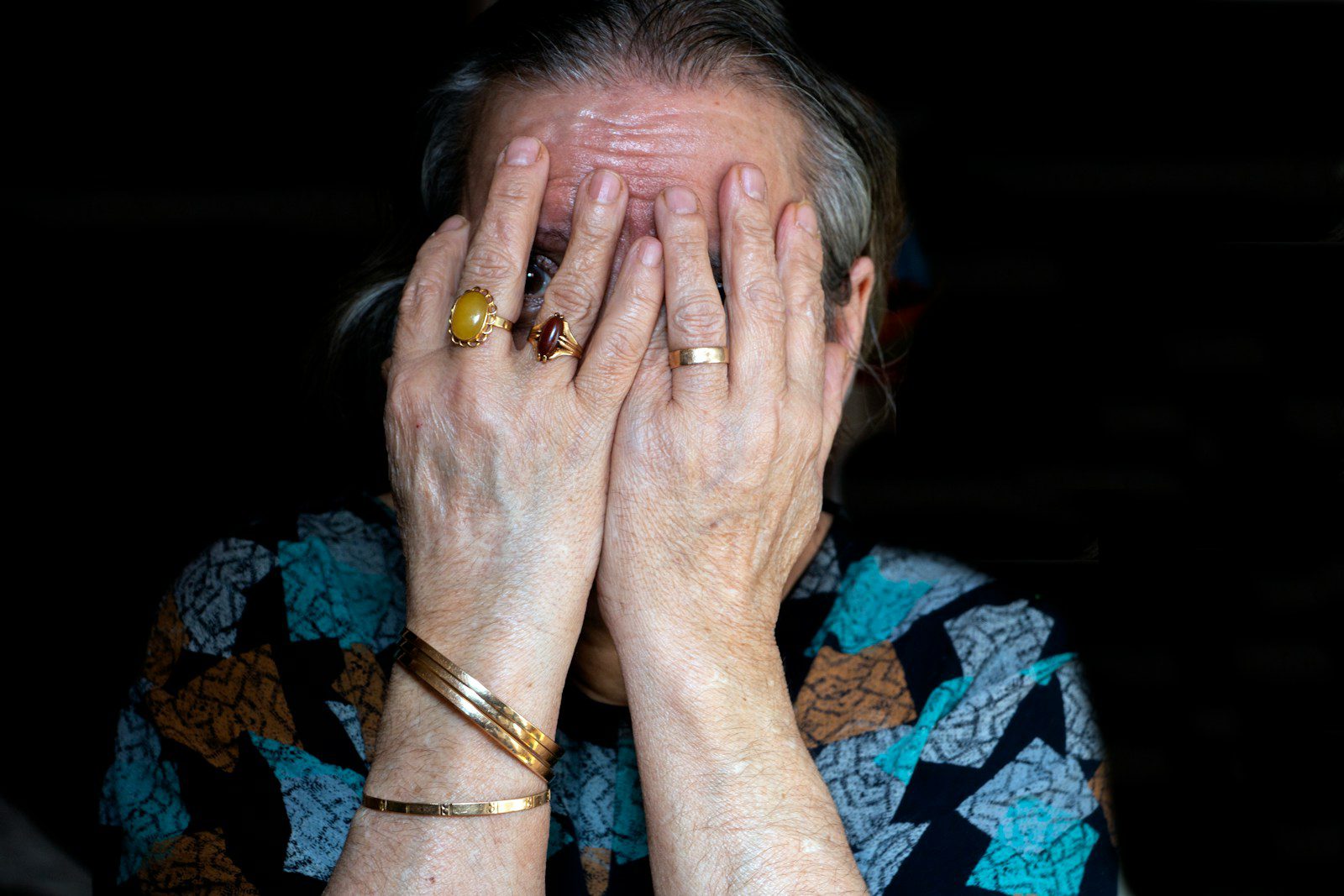 a woman covering her face with her hands