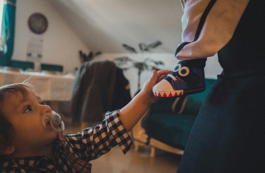 a little boy holding a pacifier in his mouth