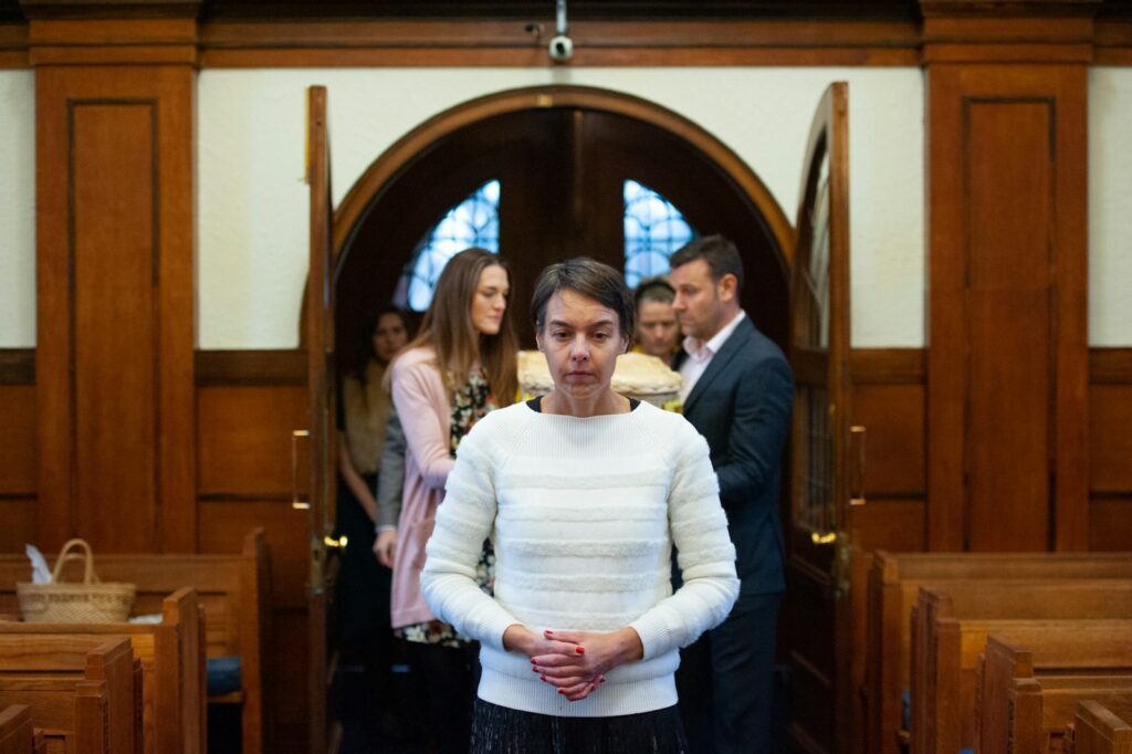 a woman standing in front of a group of people