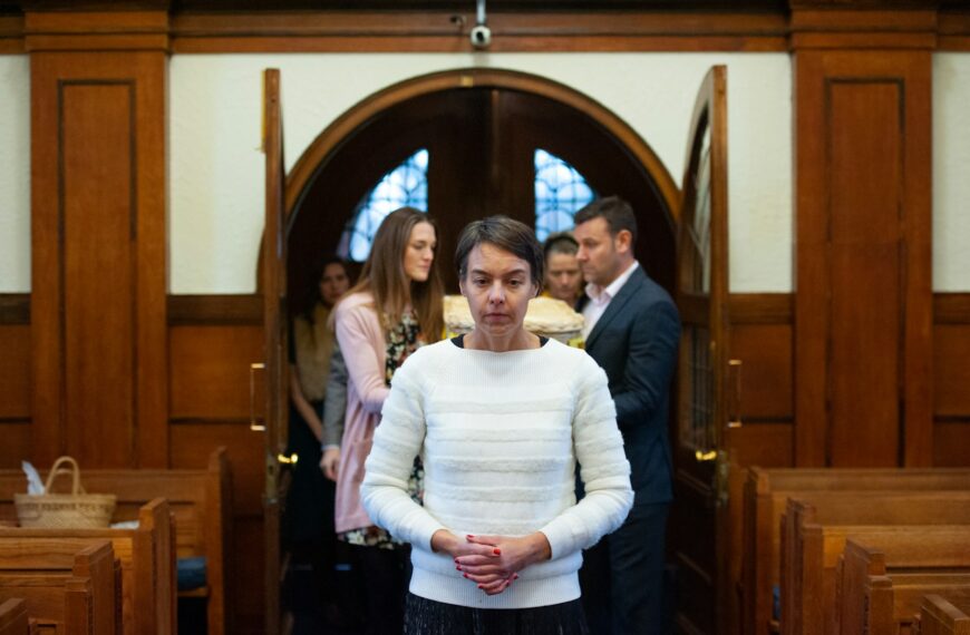 a woman standing in front of a group of people